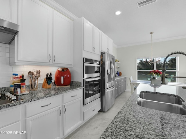 kitchen with ventilation hood, white cabinetry, appliances with stainless steel finishes, and sink