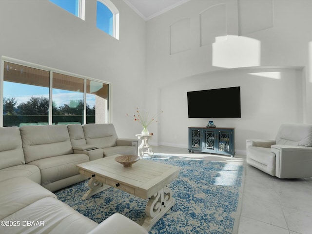 tiled living room featuring a high ceiling, ornamental molding, and a wealth of natural light