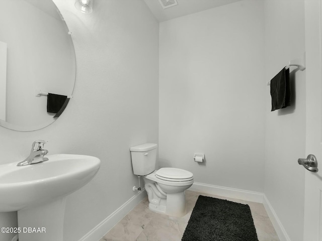 bathroom featuring toilet and sink