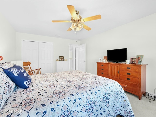 carpeted bedroom with ceiling fan and a closet