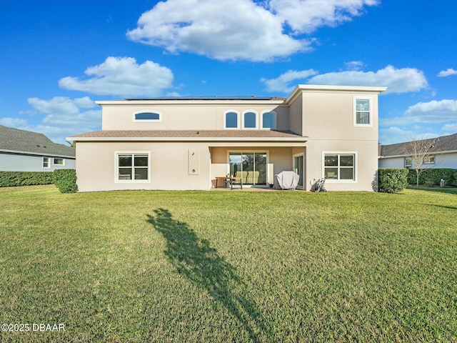 rear view of property featuring a yard and a patio area