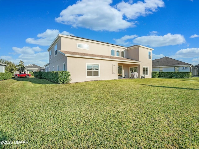 back of house featuring a lawn