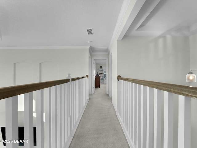 hallway with light carpet and crown molding