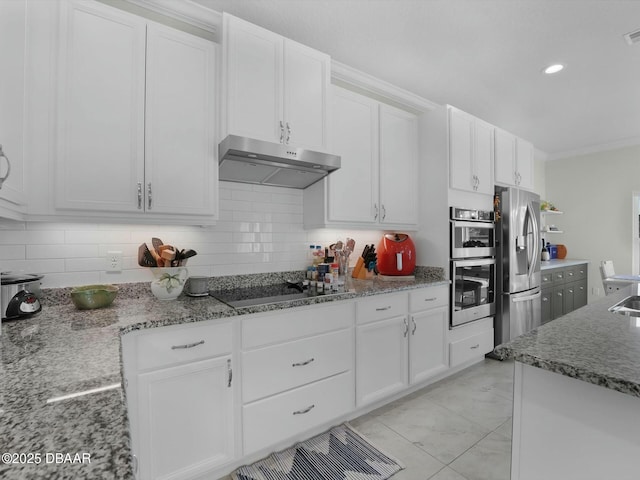 kitchen with tasteful backsplash, appliances with stainless steel finishes, stone countertops, and white cabinets