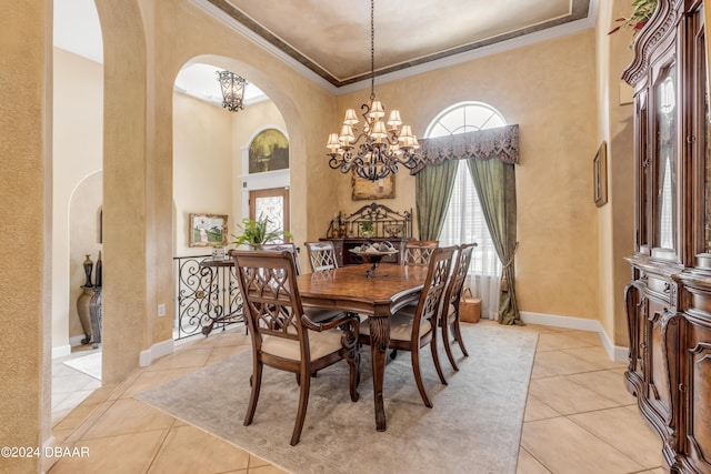 dining space with light tile patterned floors, an inviting chandelier, and crown molding