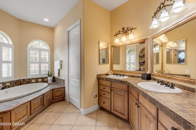 bathroom with vanity, tile patterned floors, and a bathtub