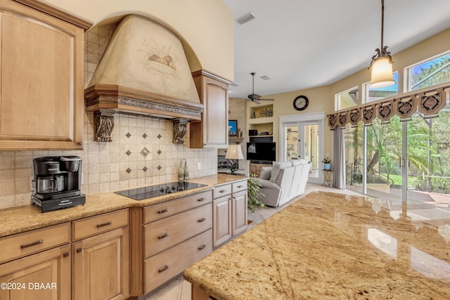 kitchen featuring light brown cabinets, pendant lighting, ceiling fan, premium range hood, and black electric stovetop