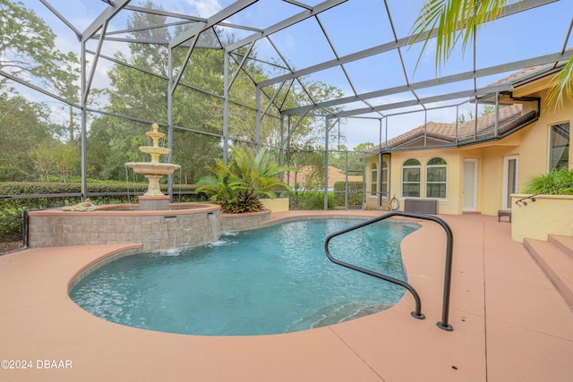 view of swimming pool featuring a lanai, pool water feature, and a patio area