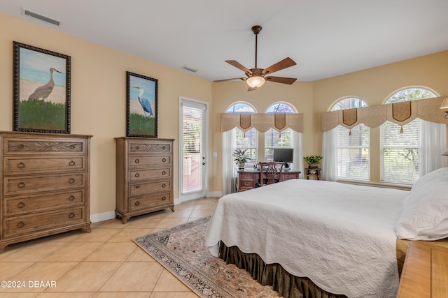 tiled bedroom with access to outside, multiple windows, and ceiling fan