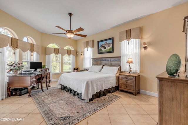 tiled bedroom featuring ceiling fan