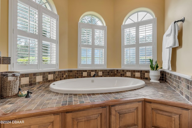 bathroom featuring a tub to relax in and a wealth of natural light