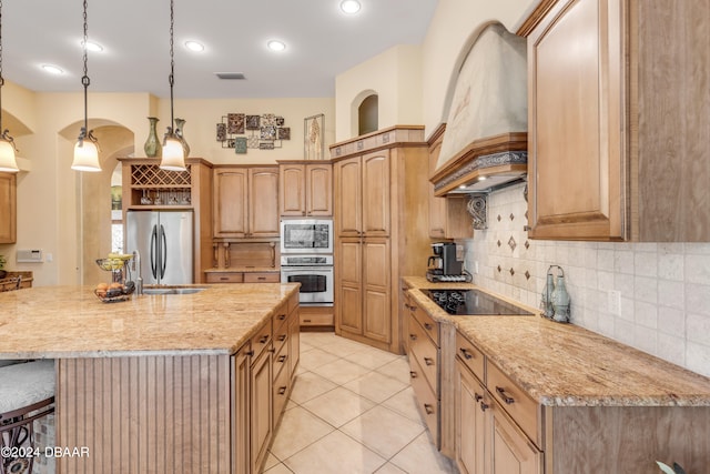 kitchen featuring premium range hood, stainless steel appliances, pendant lighting, sink, and a kitchen island with sink