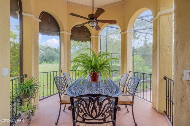 sunroom / solarium featuring ceiling fan