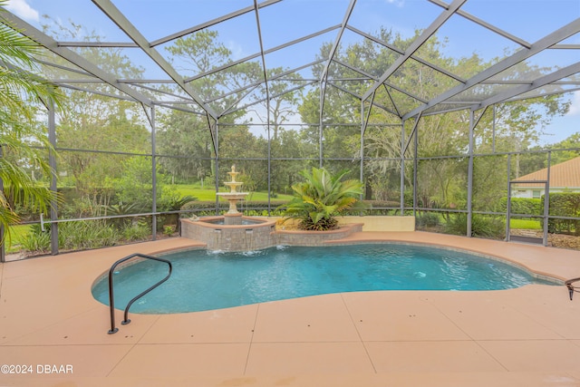 view of swimming pool featuring a patio, a lanai, pool water feature, and an in ground hot tub