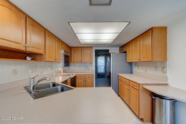130 Kimberly Dr, Ormond Beach, FL 32174 - kitchen with appliances with stainless steel finishes, a sink, and decorative backsplash