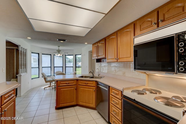 130 Kimberly Dr, Ormond Beach, FL 32174 - kitchen with stainless steel dishwasher, a sink, white electric range, a peninsula, and light countertops