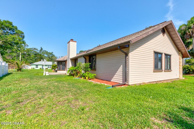130 Kimberly Dr, Ormond Beach, FL 32174 - rear view of property with a yard and a chimney