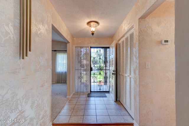 130 Kimberly Dr, Ormond Beach, FL 32174 - foyer entrance featuring light tile patterned floors, baseboards, and a textured ceiling