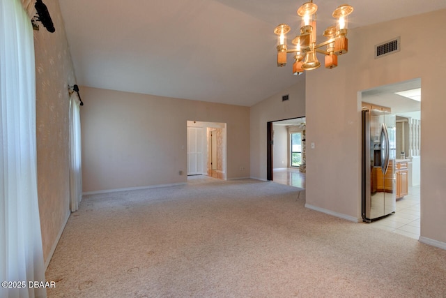130 Kimberly Dr, Ormond Beach, FL 32174 - spare room featuring light colored carpet, a chandelier, baseboards, and high vaulted ceiling