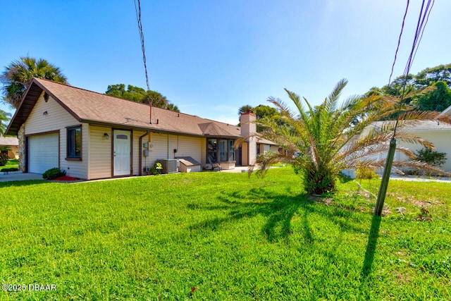 130 Kimberly Dr, Ormond Beach, FL 32174 - view of front of home featuring a garage, a front yard, central air condition unit, a chimney, and a shingled roof