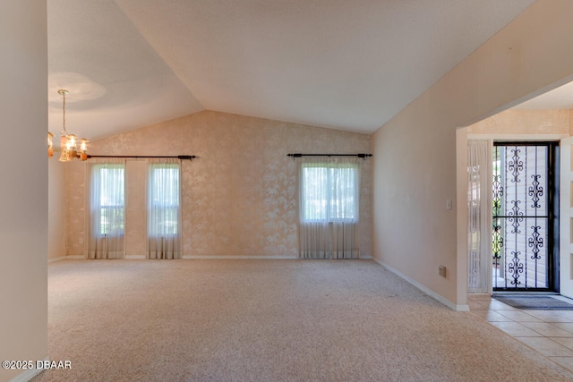 130 Kimberly Dr, Ormond Beach, FL 32174 - carpeted empty room featuring vaulted ceiling, a chandelier, and baseboards