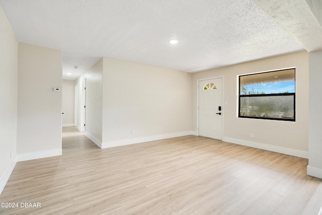 1512 Old Kings Rd, Daytona Beach, FL 32117 - spare room featuring a textured ceiling and light hardwood / wood-style flooring