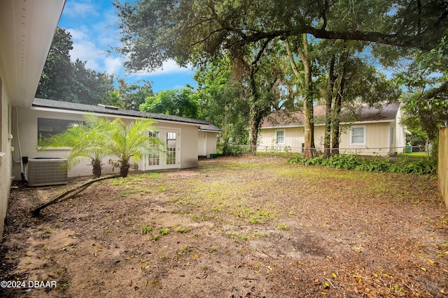 1512 Old Kings Rd, Daytona Beach, FL 32117 - view of yard featuring central air condition unit and french doors