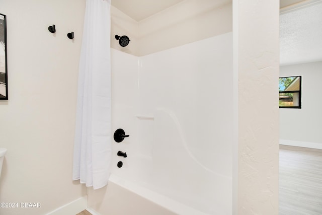 1512 Old Kings Rd, Daytona Beach, FL 32117 - bathroom with hardwood / wood-style flooring, shower / bathtub combination with curtain, and a textured ceiling