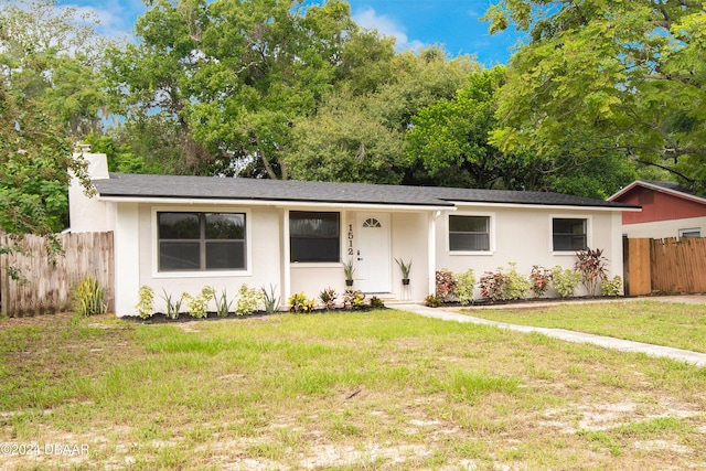 ranch-style home with a front lawn