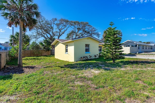 408 Frances Ter, Daytona Beach, FL 32118 - exterior space featuring a lawn, fence, and stucco siding