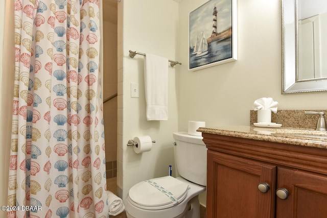 bathroom featuring toilet, vanity, and a shower with shower curtain