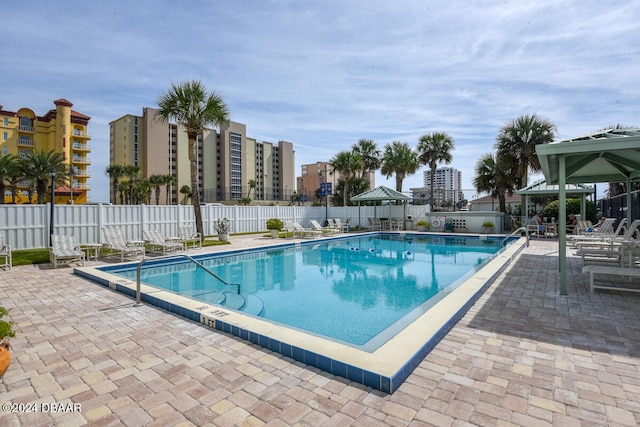 view of swimming pool featuring a patio and a gazebo