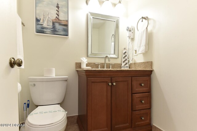 bathroom featuring tile patterned flooring, vanity, and toilet