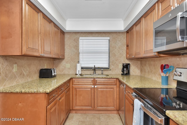 kitchen featuring light stone countertops, appliances with stainless steel finishes, sink, and crown molding