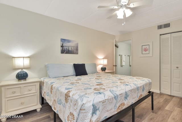 bedroom featuring ceiling fan, a closet, and light wood-type flooring