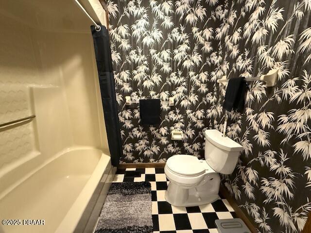 bathroom featuring toilet and tile patterned floors