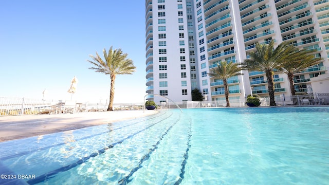 241 Riverside Dr Unit 402, Daytona Beach, FL 32117 - view of swimming pool featuring fence
