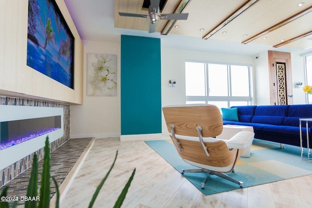 living room featuring ceiling fan and light wood-type flooring