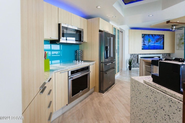241 Riverside Dr Unit 402, Daytona Beach, FL 32117 - kitchen featuring stainless steel appliances, light brown cabinets, modern cabinets, light stone countertops, and light wood-style floors