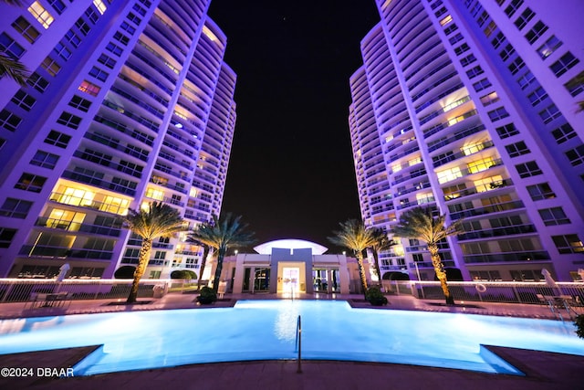 241 Riverside Dr Unit 402, Daytona Beach, FL 32117 - pool at twilight featuring a community pool and fence
