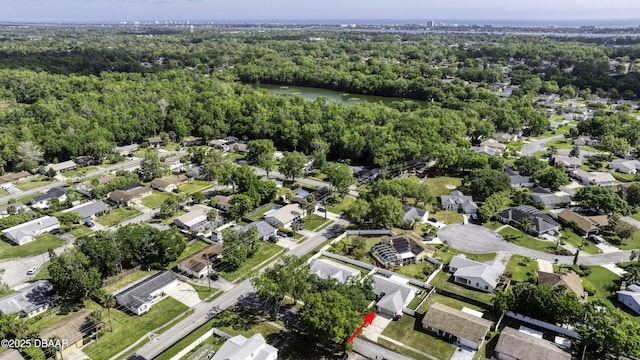 aerial view featuring a water view, a wooded view, and a residential view