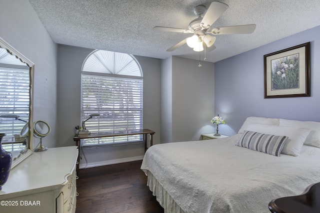 bedroom with baseboards, dark wood-type flooring, multiple windows, and a textured ceiling