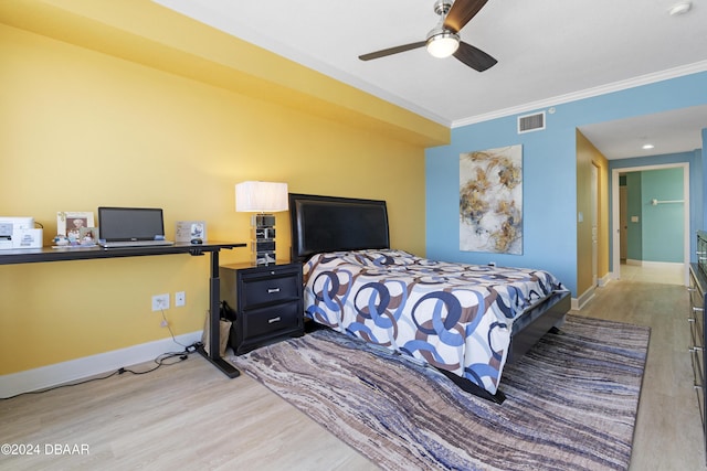 bedroom with crown molding, visible vents, ceiling fan, light wood-type flooring, and baseboards