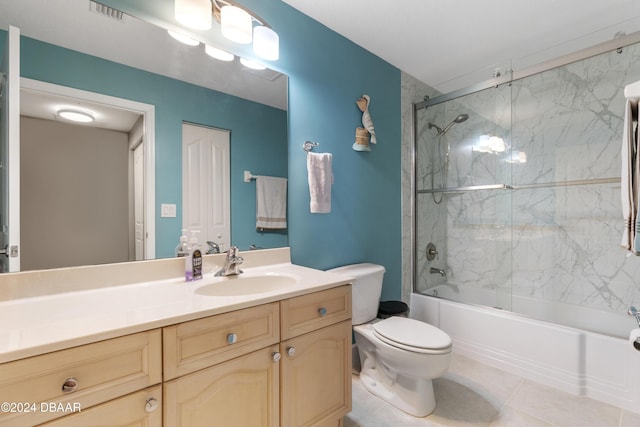 full bathroom with visible vents, toilet, combined bath / shower with glass door, vanity, and tile patterned floors