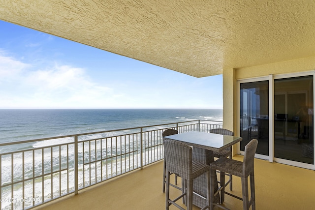 balcony with a beach view and a water view