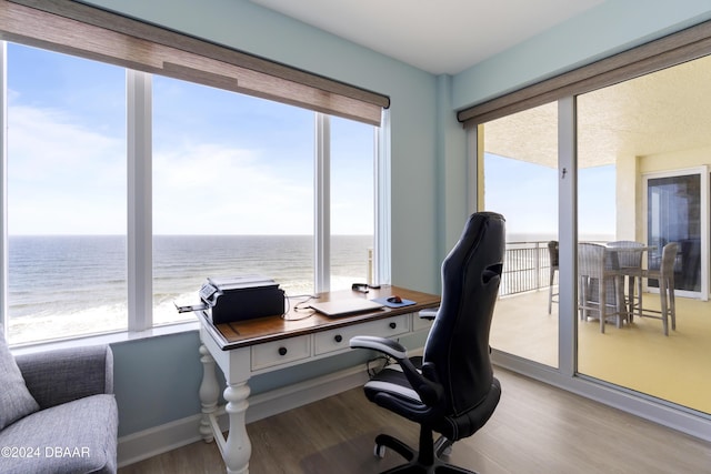 office area featuring a water view and wood finished floors