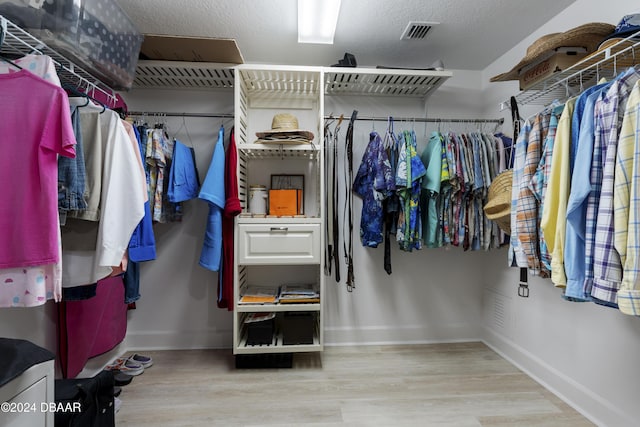 spacious closet featuring visible vents and wood finished floors