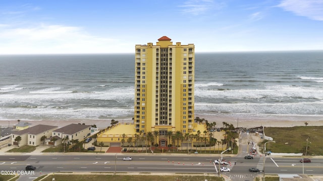 birds eye view of property with a beach view and a water view