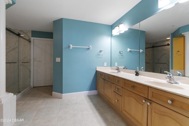 full bath featuring ornate columns, tile patterned flooring, a marble finish shower, and a sink