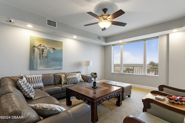 living area featuring baseboards, visible vents, a ceiling fan, and recessed lighting